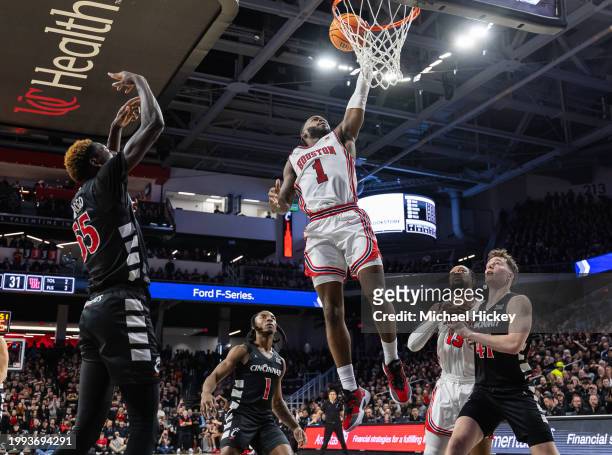 Jamal Shead of the Houston Cougars shoots the ball over Simas Lukosius of the Cincinnati Bearcats during the second half at Fifth Third Arena on...