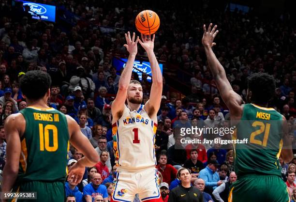 Hunter Dickinson of the Kansas Jayhawks shoots against RayJ Dennis and Yves Missi of the Baylor Bears during the first half at Allen Fieldhouse on...