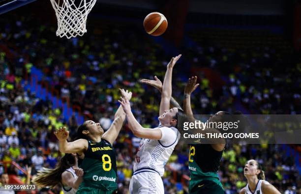 Serbia's Angela Dugalic tries to score a basket as Brazil's Tainá Paixão and Damiris Dantas try to block it during the women's Pre-olympic Tournament...