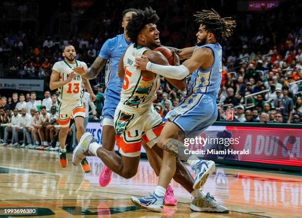 Miami's Norchad Omier battles North Carolina's RJ Davis in the paint in the first half at the Watsco Center on Saturday, Feb. 10 in Coral Gables,...