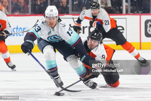 Brandon Tanev of the Seattle Kraken battles with Jamie Drysdale of the Philadelphia Flyers in the first period at the Wells Fargo Center on February...