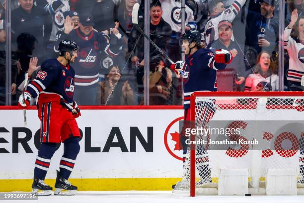 Nino Niederreiter and Adam Lowry of the Winnipeg Jets celebrate a first period goal against the Pittsburgh Penguins at the Canada Life Centre on...