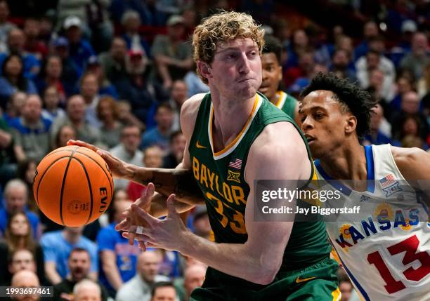 Elmarko Jackson of the Kansas Jayhawks knocks the ball away from Caleb Lohner of the Baylor Bears during the second half at Allen Fieldhouse on...