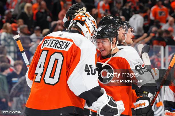 Cal Petersen of the Philadelphia Flyers celebrates with Cam Atkinson after the game against the Seattle Kraken at the Wells Fargo Center on February...