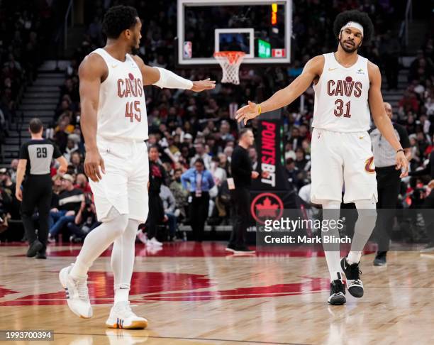 Jarrett Allen and Donovan Mitchell of the Cleveland Cavaliers celebrate against the Toronto Raptors during the second half of their basketball game...