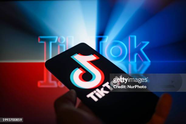 The TikTok logo is being displayed on a smartphone with TikTok visible in the background in this photo illustration in Brussels, Belgium, on February...