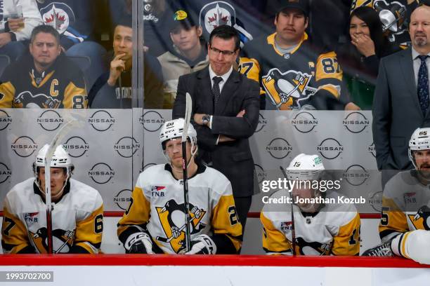 Head Coach Mike Sullivan of the Pittsburgh Penguins looks on from the bench during second period action against the Winnipeg Jets at the Canada Life...