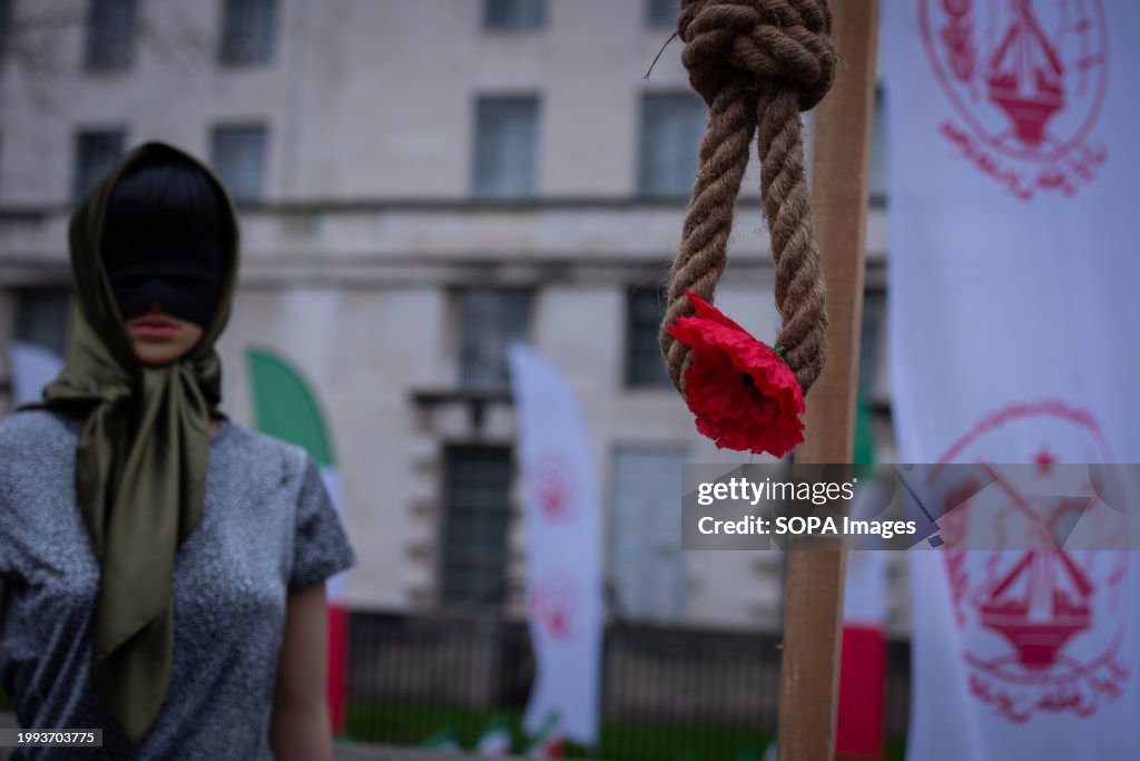 A masked sculpture is juxtaposed with a noose and a rose...