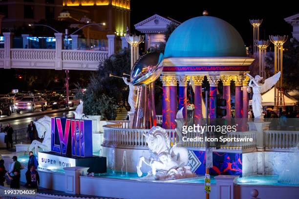 Sign of the Super Bowl LVIII logo and a replica of the Vince Lombardi Trophy on display in front of Caesars Palace Hotel & Casino at the corner of...