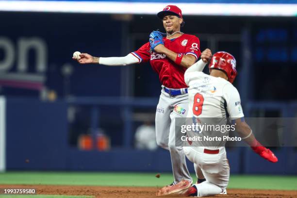 Sergio Alcantara of Tigres del Licey of Dominican Republic puts out Ricardo Cespedes of Federales de Chirique of Panama on a play at second base in...