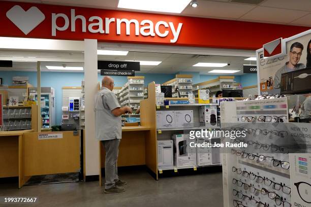 Customer visits a CVS pharmacy store on February 07, 2024 in Miami, Florida. The company lowered its 2024 adjusted earnings forecast to at least...