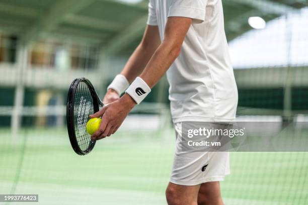 tennis player with racket serving ball - tennis game stock pictures, royalty-free photos & images