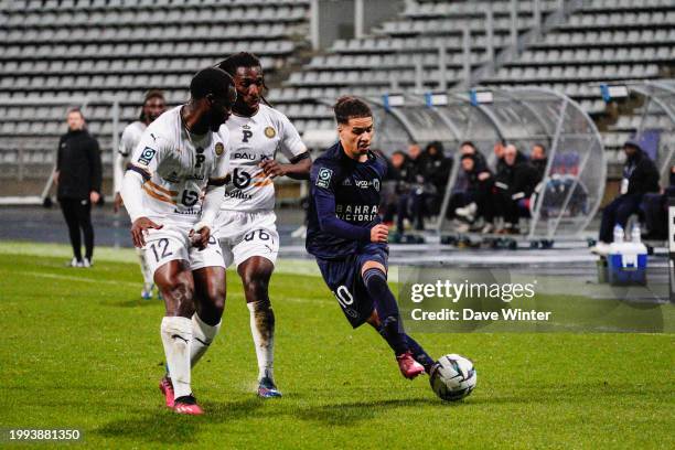 Ilan Kebbal of Paris FC takes on Sessi DAlmeida of Pau and Jordy Gaspar of Pau during the Ligue 2 BKT match between Paris Football Club and Pau...