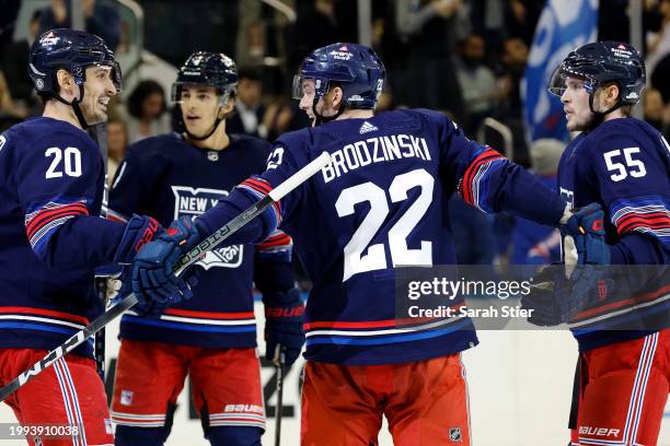 Chris Kreider and Ryan Lindgren celebrate with Jonny Brodzinski of the New York Rangers after his goal during the second period against the Tampa Bay...