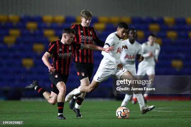 Ellis Lehane of Tottenham Hotspur runs with the ball whilst under pressure from Ollie Morgan and Josh Salmon of AFC Bournemouth during the FA Youth...