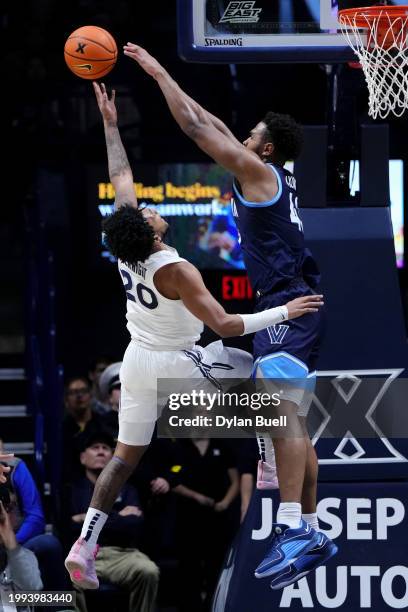 Dayvion McKnight of the Xavier Musketeers attempts a shot while being guarded by Eric Dixon of the Villanova Wildcats in the second half at the...