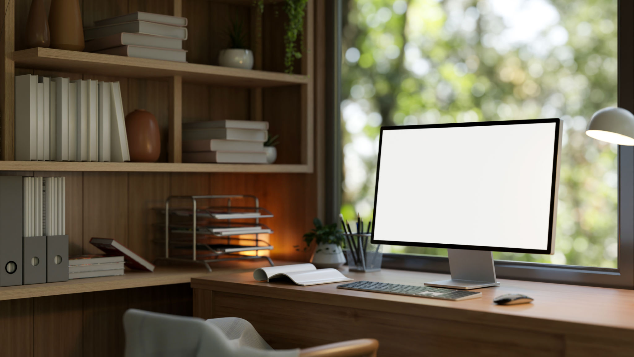A computer mockup on a wooden desk against the window in a modern and comfortable home office. A computer mockup on a wooden desk against the window in a modern and comfortable home office.