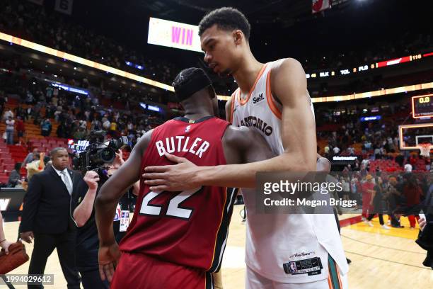 Jimmy Butler of the Miami Heat and Victor Wembanyama of the San Antonio Spurs embrace on the court after their game at Kaseya Center on February 07,...