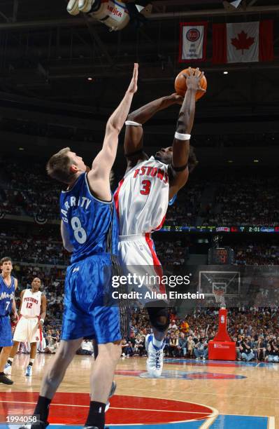 Ben Wallace of the Detroit Pistons takes a fade-away jump shot over Pat Garrity of the Orlando Magic in Game seven of the Eastern Conference...