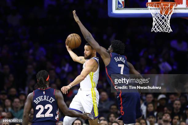 Stephen Curry of the Golden State Warriors attempts a pass behind Mo Bamba of the Philadelphia 76ers during the third quarterat the Wells Fargo...
