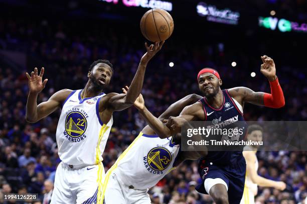 Andrew Wiggins of the Golden State Warriors reaches for a rebound past Paul Reed of the Philadelphia 76ers at the Wells Fargo Center on February 07,...