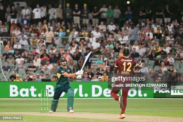 Australia's Tim David plays a shot off West Indies' Andre Russell during the second Twenty20 international cricket match between Australia and West...