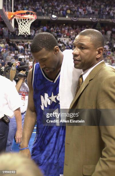 Tracy McGrady and head coach Doc Rivers of the Orlando Magic stoically walk off the floor after the loss in Game seven against the Detroit Pistons in...