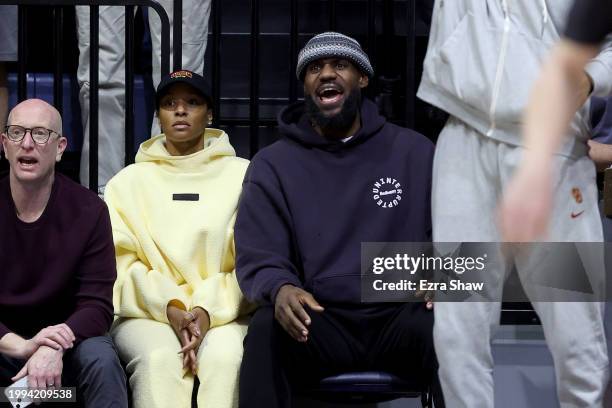 Lebron James of the Los Angeles Lakers, and his wife Savannah James, watch their son Bronny James of the USC Trojans play against the California...