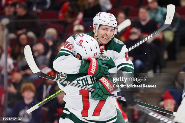 Marcus Foligno of the Minnesota Wild celebrates a goal with Vinni Lettieri against the Chicago Blackhawks during the third period at the United...