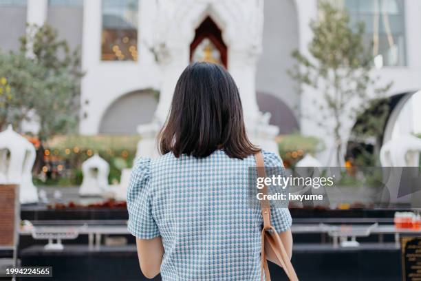 tourist praying at trimurti shrine in bangkok - trust god stock pictures, royalty-free photos & images