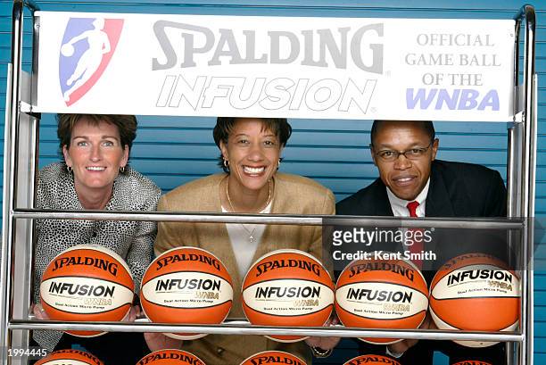 Head coach Trudi Lacey , Fred Williams , and Gail Hook of the Charlotte Sting pose for a picture with the newly designed WNBA Infusion Ball from...
