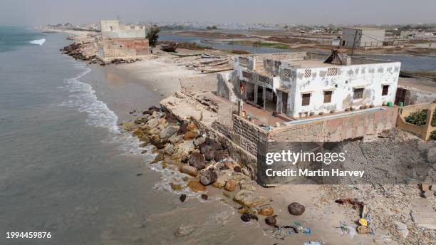aerial. coastal erosion caused by rising sea levels due to climate change, saint louis, senegal - eroded stock pictures, royalty-free photos & images