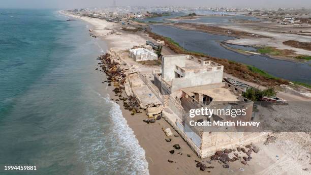 aerial. coastal erosion caused by rising sea levels due to climate change, saint louis, senegal - senegal landscape stock pictures, royalty-free photos & images