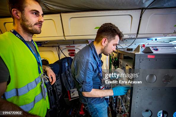 Xmx Instrument NASA personnel inspect an instrument used to measure air quality ...