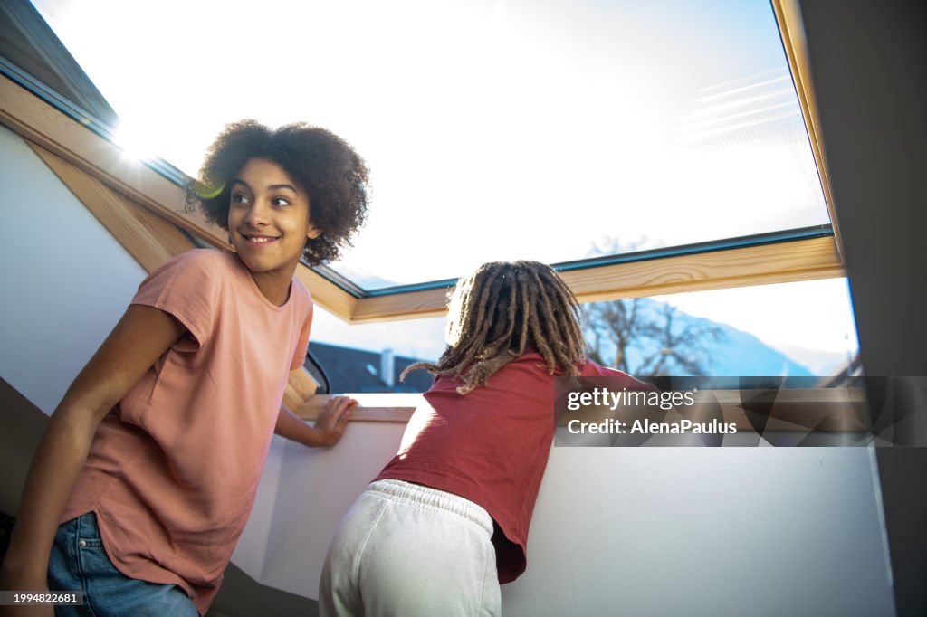 Children look through the large skylight