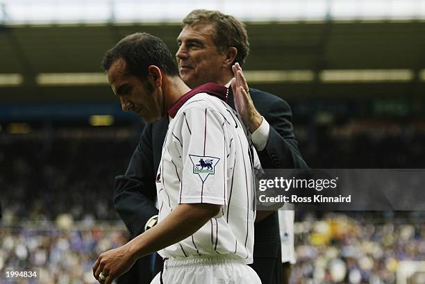 Paulo Di Canio of West Ham United receives a pat on the back from West Ham United caretaker manager Trevor Brooking after his they are relegated...