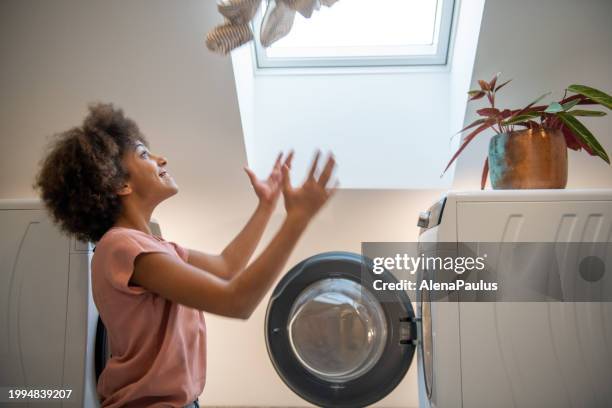 young girl doing laundry - open day 13 stock pictures, royalty-free photos & images