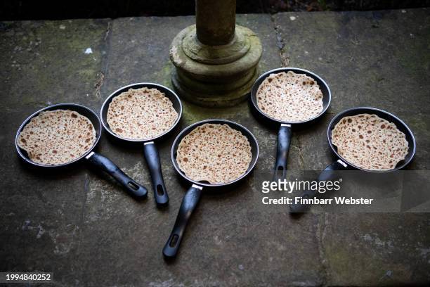 Pans and pancakes are ready for choristers to practice their pancake flipping in the Cloisters at Salisbury Cathedral, on February 08, 2024 in...