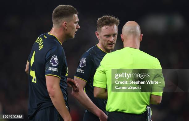 Newcastle United's Sean Longstaff in conversation with Referee Anthony Taylor as team-mate Sven Botman looks on during the Premier League match...