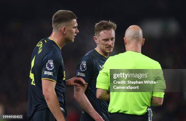 Newcastle United's Sean Longstaff in conversation with Referee Anthony Taylor as team-mate Sven Botman looks on during the Premier League match...