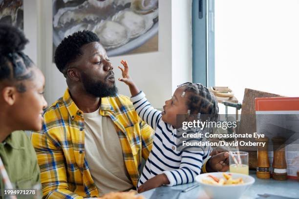 medium shot of family in cafe - blue checked pattern stock pictures, royalty-free photos & images