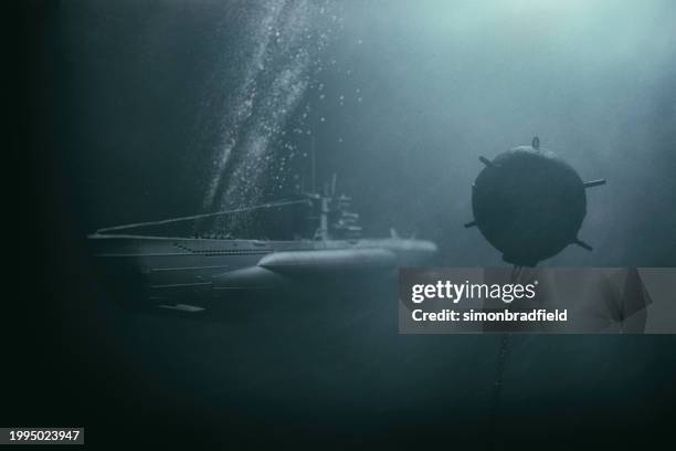 submarine navigating a deep sea minefield - undersea mines stock pictures, royalty-free photos & images