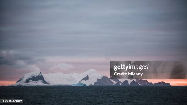 antarctica coastal islands sunset iceberg under colorful skyscape panorama - antarctica sunset stock pictures, royalty-free photos & images