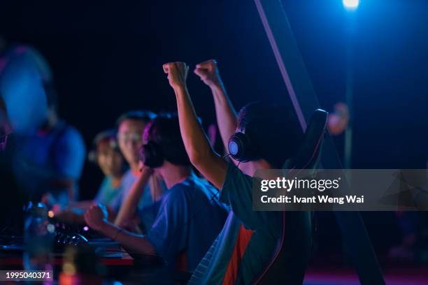 asian male esport player won hand gesture - esports stock pictures, royalty-free photos & images