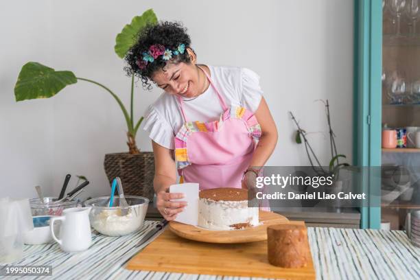 female chef making cake - confectioner stock pictures, royalty-free photos & images