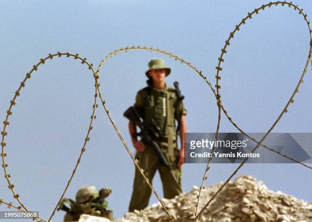 An Israeli soldier stands guard at the Lebanese-Israeli border near the village of Markaba, on October 19, 2000.