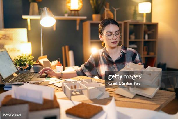 young female architect making an architectural model in her home office - architectural model stock pictures, royalty-free photos & images