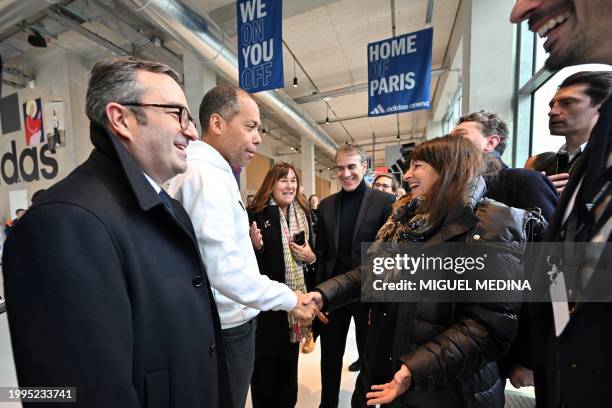 Paris' mayor Anne Hidalgo shakes hands with General Director of Adidas Europe Mathieu Sidokpohou next to Managing Director for Bouygues Batiment...