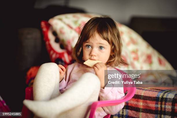 toddler eat biscuits at home. - baby cartoon characters stock pictures, royalty-free photos & images