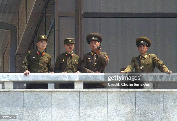 North Korean soldiers look over to the southern area May 13 2003 at the border village of Panmunjom in the demilitarized zone between the two Koreas...